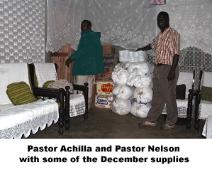Pastor Achilla and Pastor Nelson with some of the December supplies